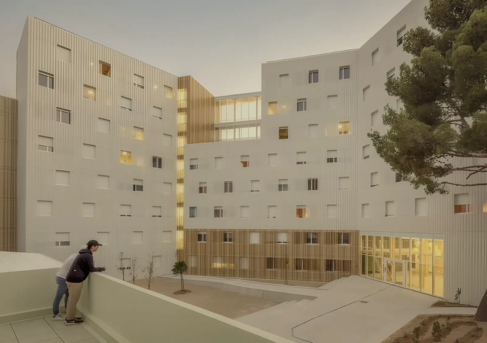 Reference photograph of a completed seven-storey student residence with a pale ribbed facade around a courtyard